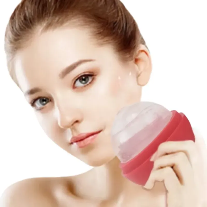 Woman using red ice roller on cheek for facial massage