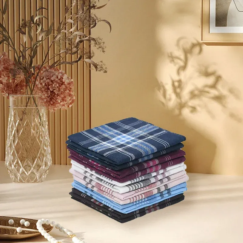 Stack of men's pocket handkerchiefs set placed on a table, surrounded by decorative elements.