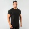 Man displaying a sleek black, short-sleeve t-shirt with a timeless design.