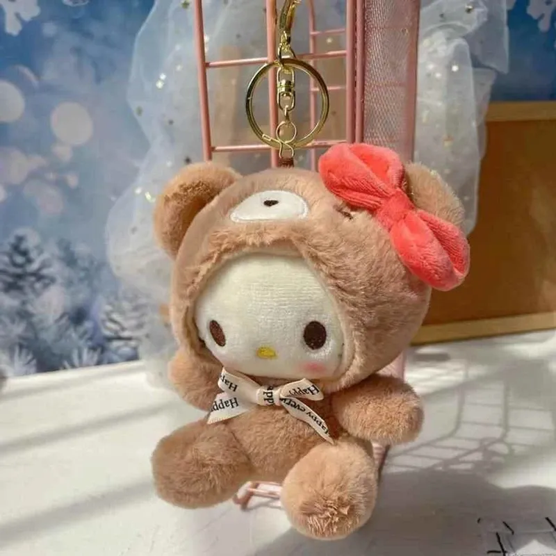 Charming brown plush keychain with a Hello Kitty-inspired design and a vibrant red bow.