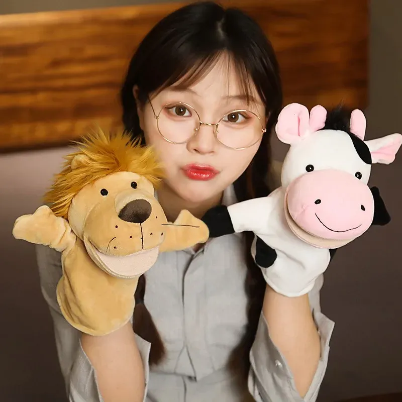 A person holding two finger puppets, one resembling a lion and the other a cow, showcasing their playful interaction.