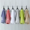 Colorful Soft Versatile Cotton Handkerchiefs hanging on hooks, adding a pop of color to the bathroom decor.