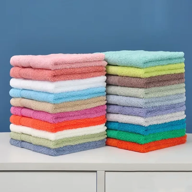 Two stacks of Cotton Hand Towels Set in assorted colors, placed side by side on a countertop.