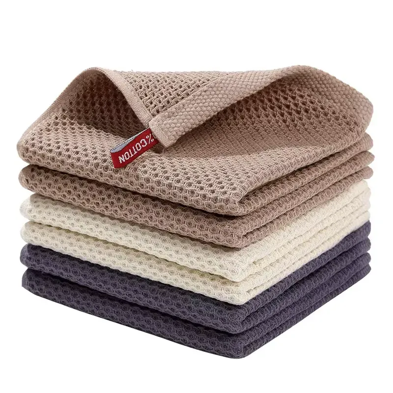 Stack of Cotton Kitchen Dish Cloths in a variety of soft, neutral colors, showcasing their textured weave and absorbent properties.