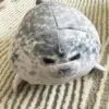 A close-up of the Kaiyukan Seal Plush Toy, showcasing its adorable face and soft spotted fur.