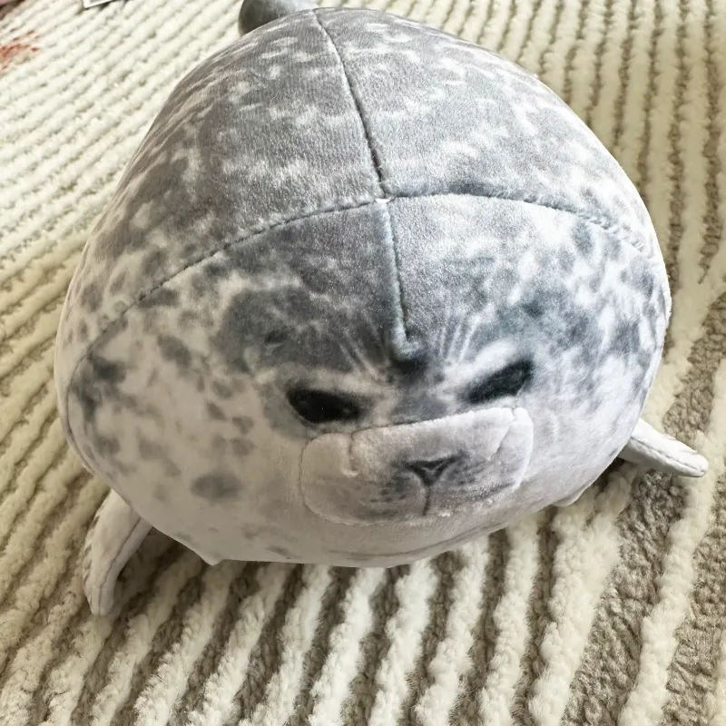 A close-up of the Kaiyukan Seal Plush Toy, showcasing its adorable face and soft spotted fur.
