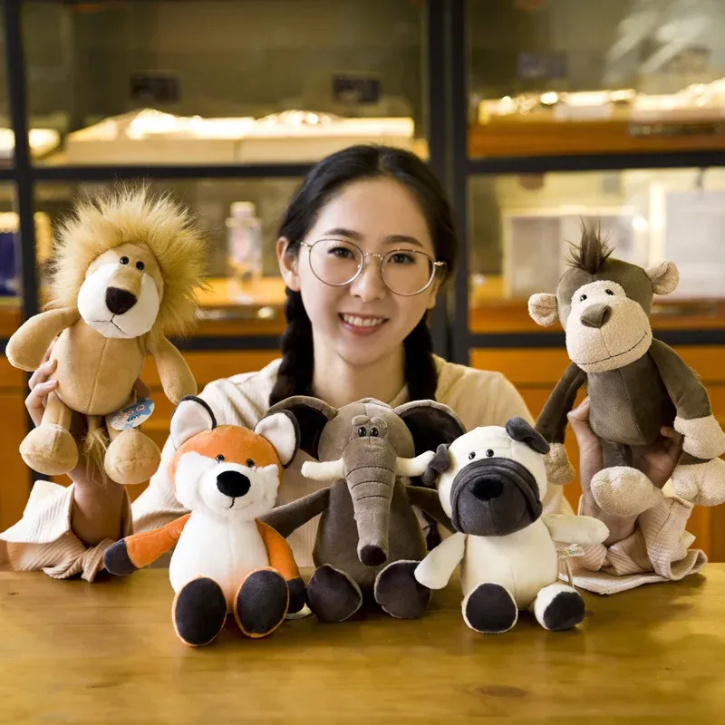 A smiling person holding a variety of kawaii jungle animal plush toys, including a lion, fox, elephant, dog, and monkey.