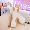 Adorable Long Cat Plush Toys sitting on a couch, showcasing their cute and cozy designs.