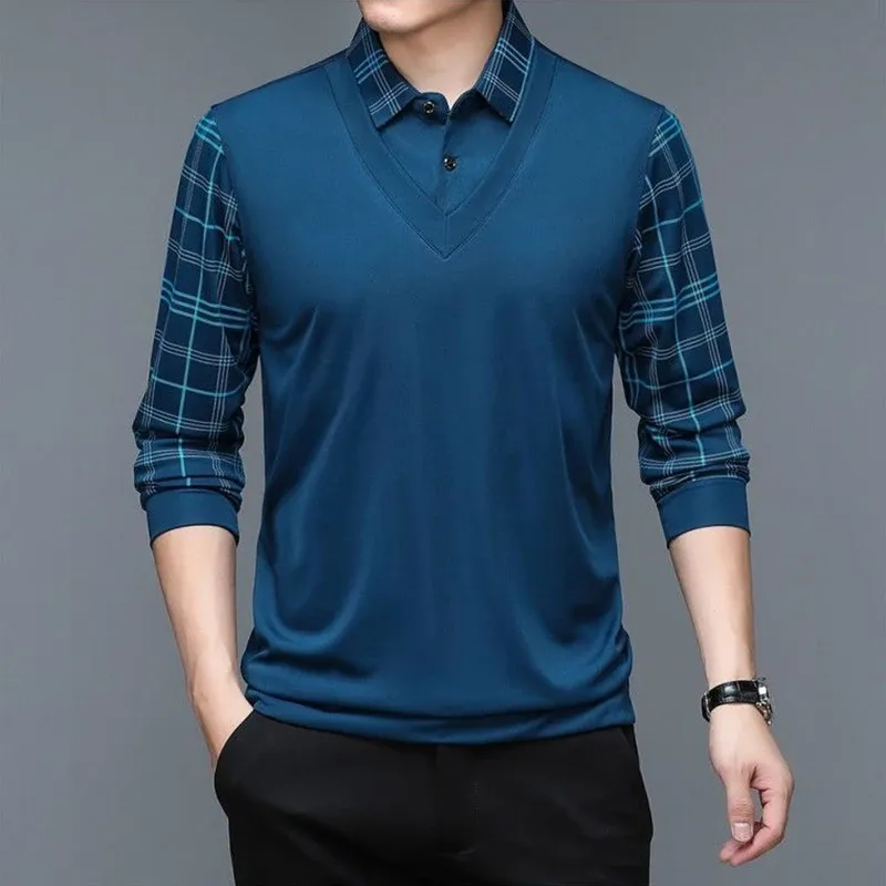 A man casually posing while wearing a men's long sleeve polo shirt with plaid sleeves, demonstrating its relaxed and stylish appeal.