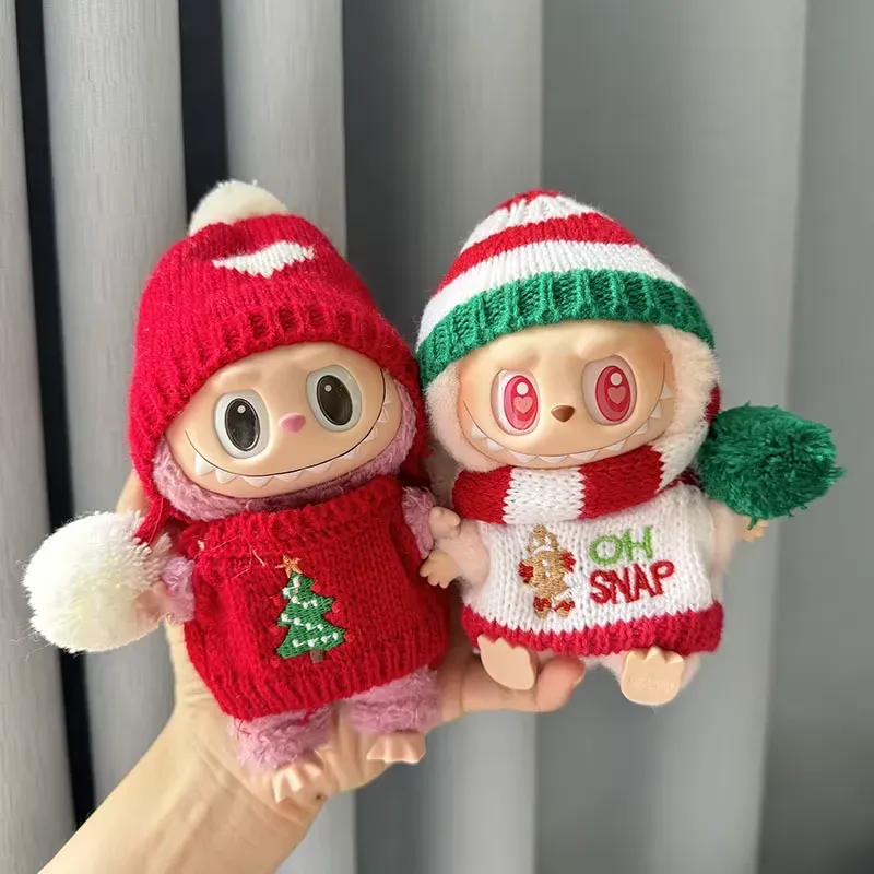 Two Mini plush dolls dressed in festive Labubu winter clothes, featuring red and green knit outfits with holiday designs.