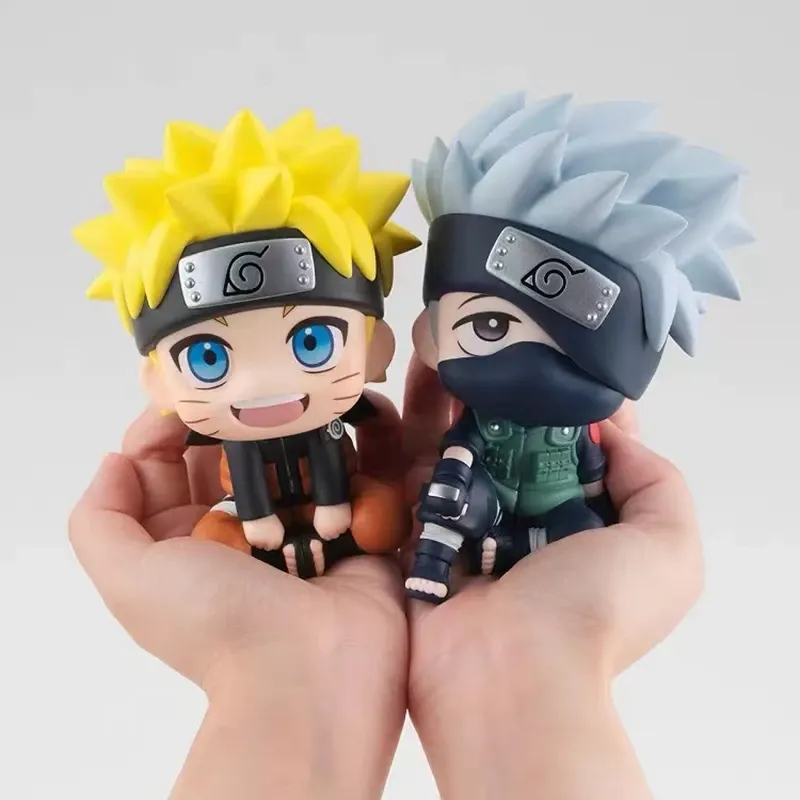 Two Naruto Q Version Figures held in hands, featuring Naruto and Kakashi in their iconic outfits.