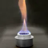 Portable aluminum camping stove with a bright blue and orange flame, showcasing its efficient performance.
