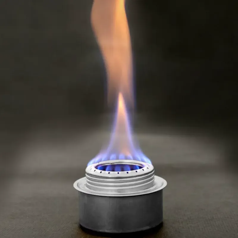 Portable aluminum camping stove with a bright blue and orange flame, showcasing its efficient performance.