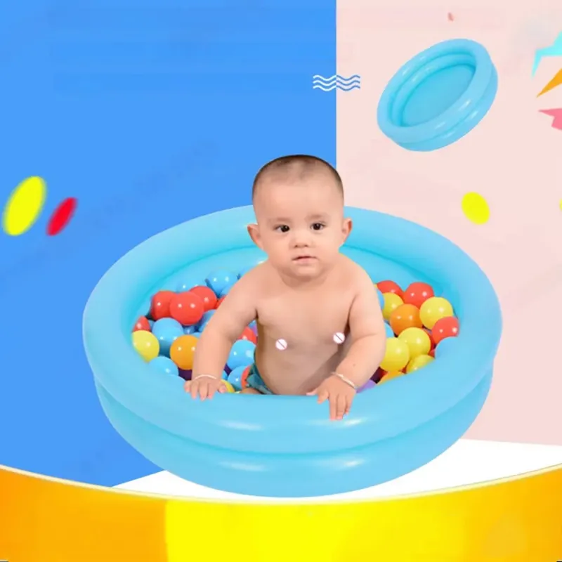 Baby enjoying a fun bath in the portable inflatable baby pool filled with colorful balls.