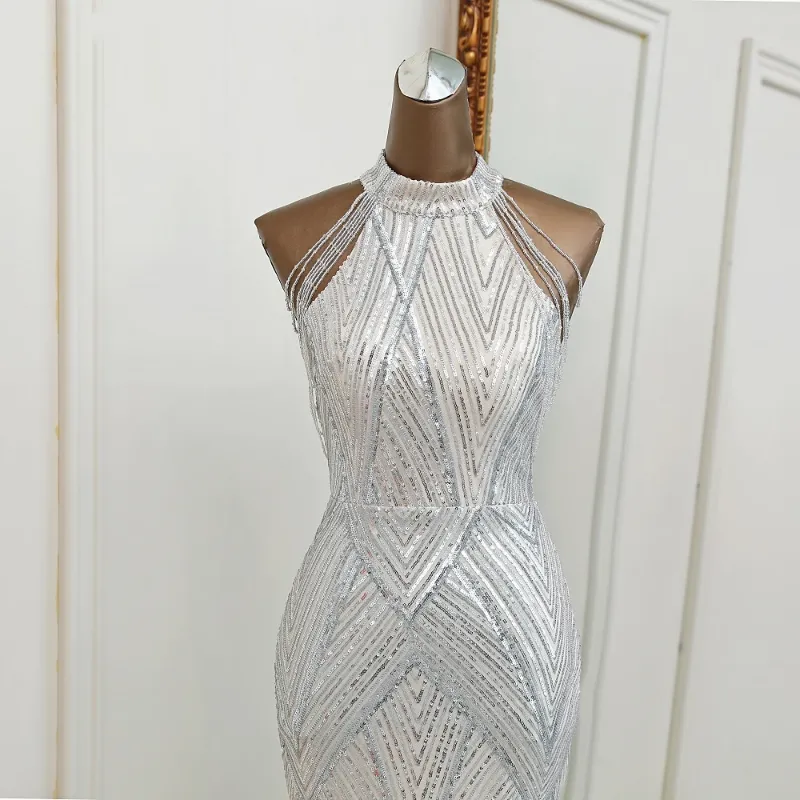 Silver mermaid evening dress with intricate sequin detailing and a high neckline.