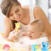 Colorful baby bath toys floating next to a swimming ring in a bathtub