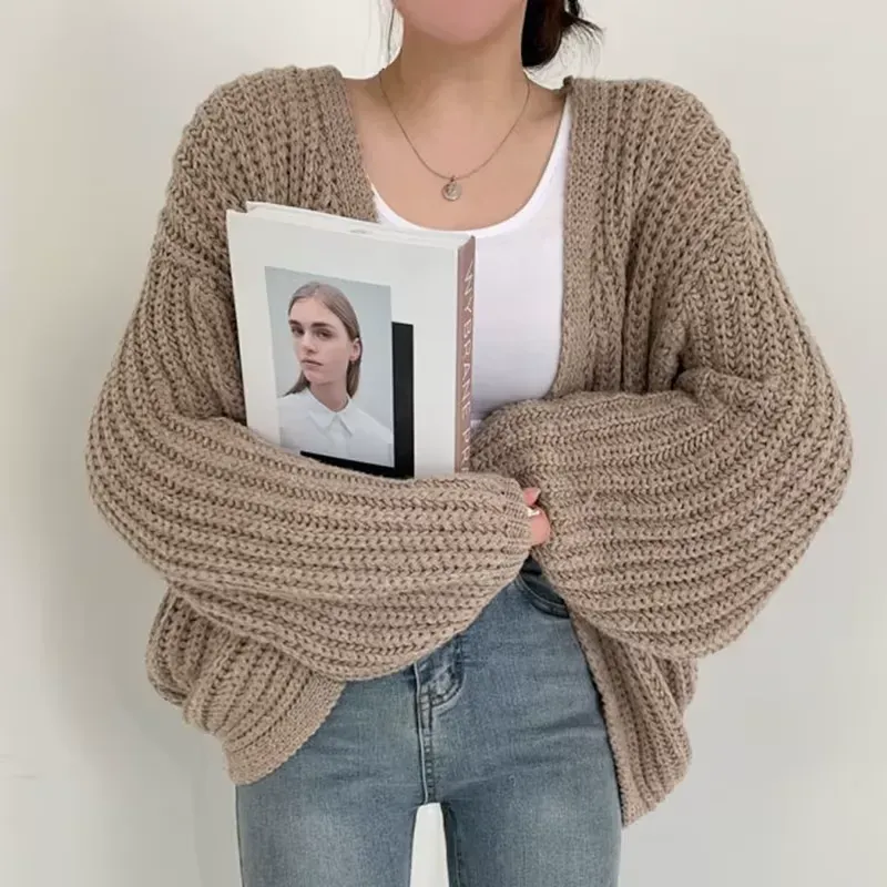 Vintage Harajuku Lantern Sleeve Cardigan in beige, styled with a book for a chic and intellectual vibe.