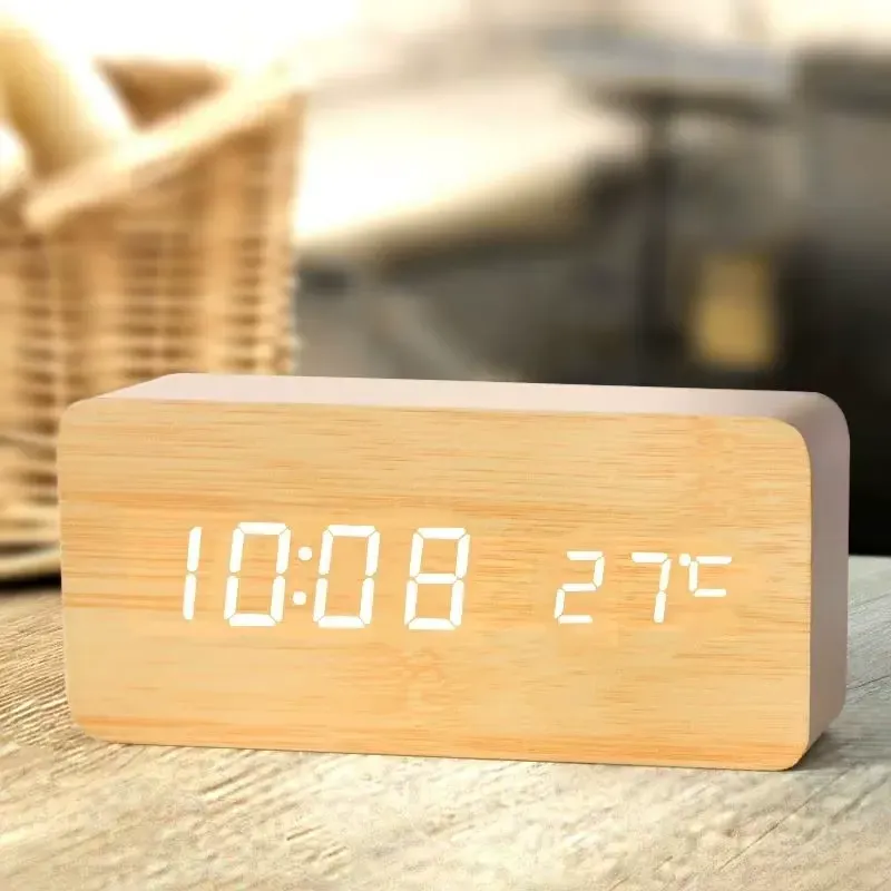 Wooden digital alarm clock displaying the time as 10:08 and temperature as 27°C.