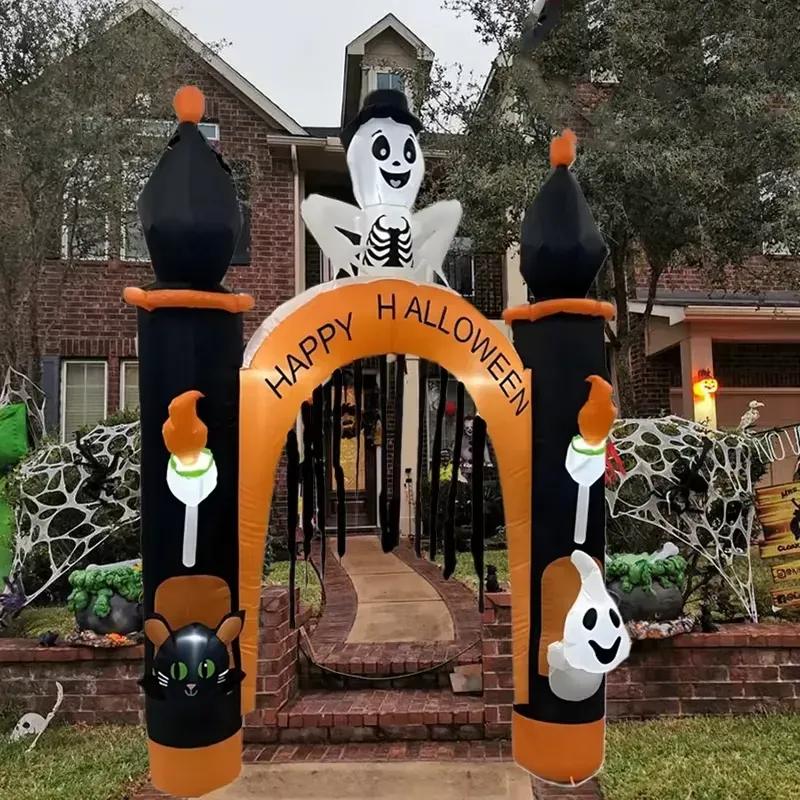 Inflatable Halloween archway with pumpkins and LED lights, standing at a house entrance at night.