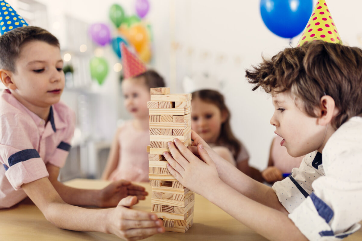 kids are playing JENGA game