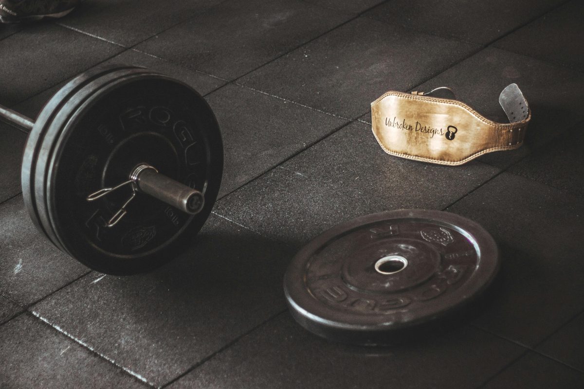 barbell with some weights on it and a lifting belt