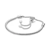 Close-up of star and heart pendants on charm bracelet for women