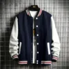 Stylish navy blue men's bomber jacket fleece with white sleeves and bold striped cuffs.
