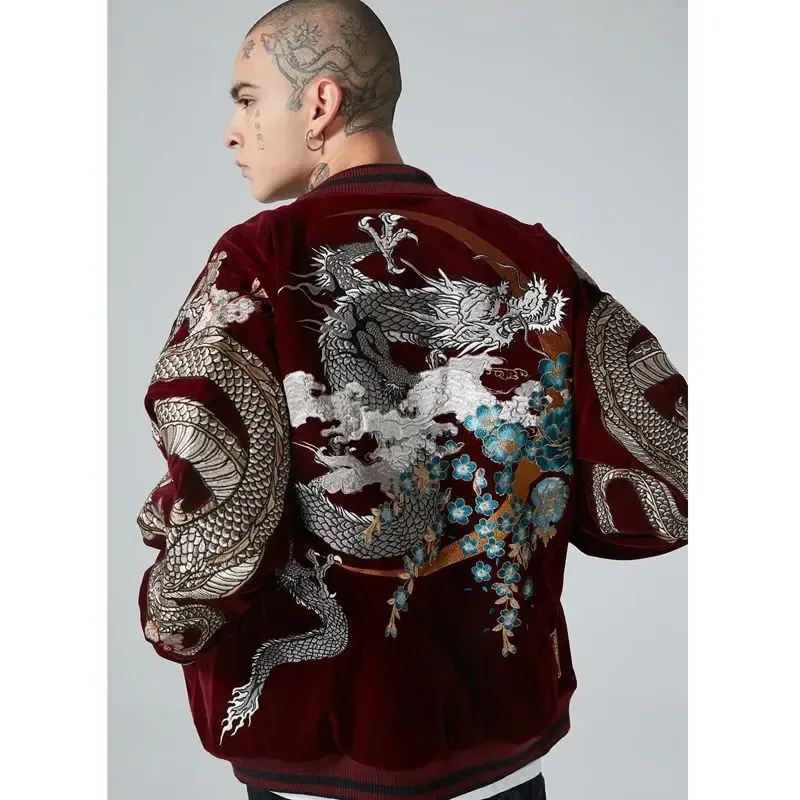 A person wearing a red baseball uniform coat with elaborate dragon and floral embroidery on the back.