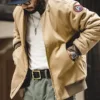 Men’s bomber jacket layered with hoodie for streetwear look