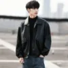 Front view of a black mens loose leather jacket paired with jeans for a trendy look.