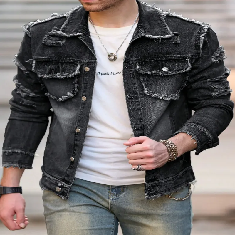 Man wearing a Men's Retro Denim Jacket in black, featuring frayed edges and layered over a white shirt.