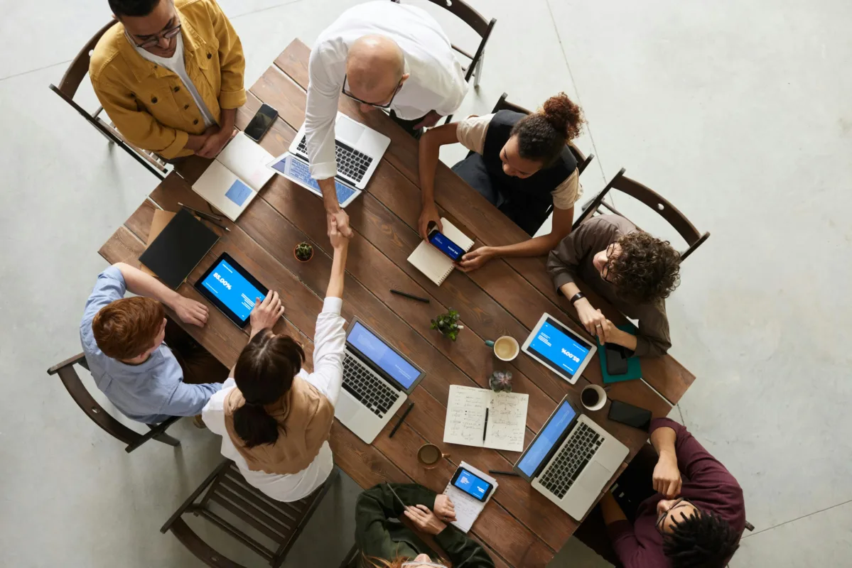 people around the table working with computers