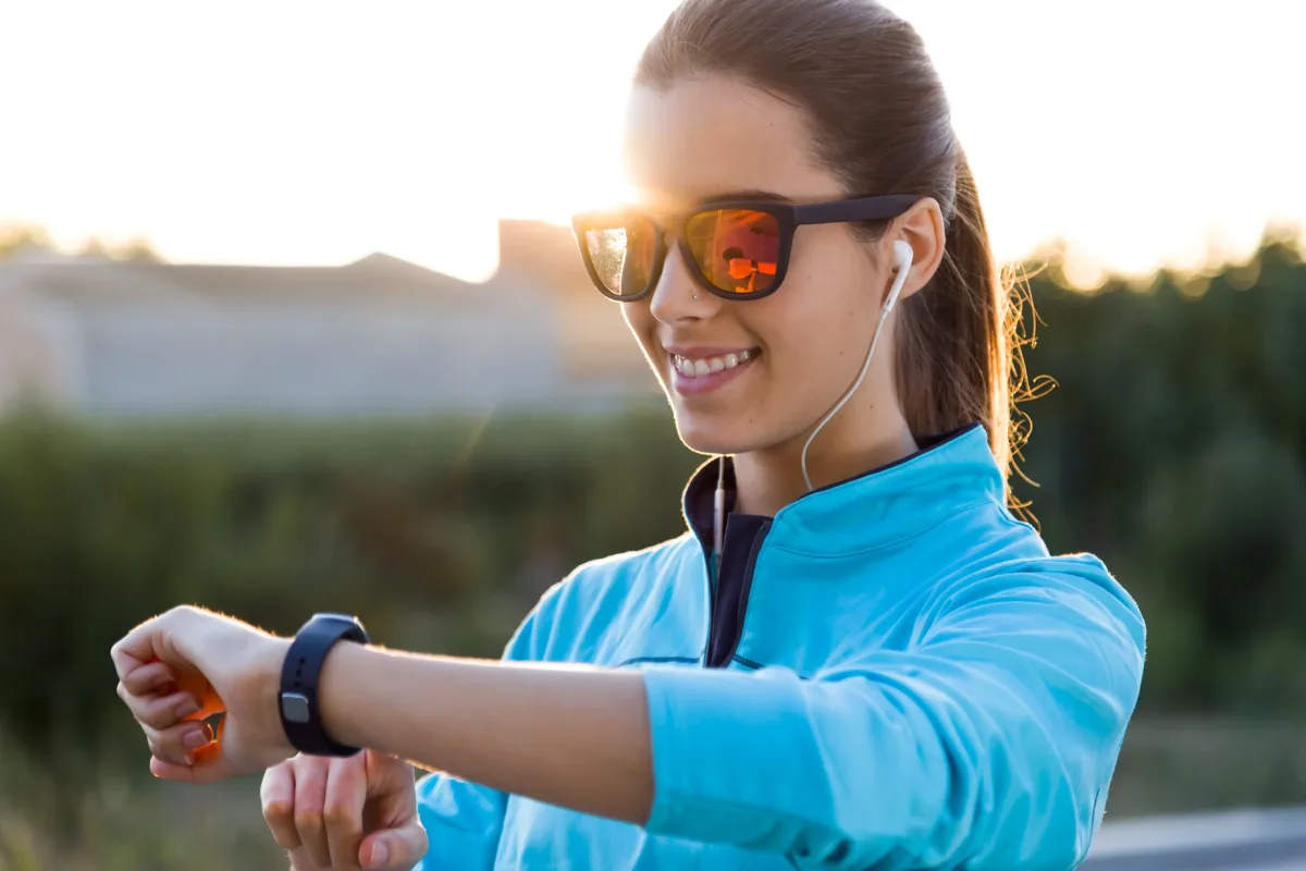 happy and nice girl is watching the smartwatch