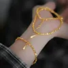 24K real gold bracelet with shattered gold droplets on woman's wrist