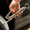 Rubber plug kit being used on a punctured tire.