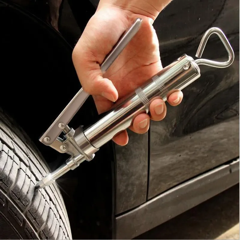 Rubber plug kit being used on a punctured tire.