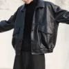 Model showcasing a sleek black Korean style men leather jacket with a modern and stylish design.