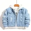 Front view of a light blue men's destroyed denim jacket with a white hoodie underneath.