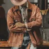 Man wearing a vintage denim jacket men in brown, accessorized with a cowboy hat and gloves, standing confidently.