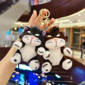 Two adorable Disney Lucifer Cat Plush Keychains held in hand, showcasing their fluffy and expressive designs.